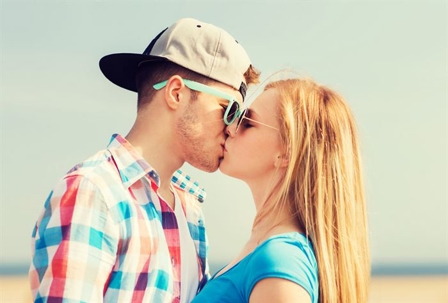 Two young people kissing.